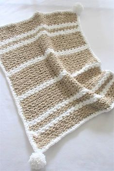 a crocheted blanket laying on top of a bed