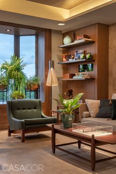 a living room filled with furniture next to a large window covered in plants and potted plants