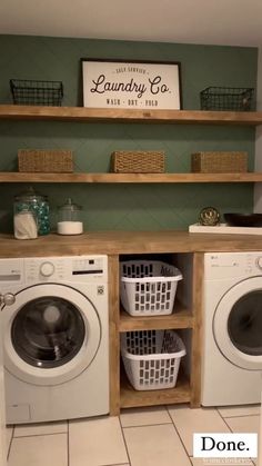 a washer and dryer in a laundry room with baskets on the shelf above