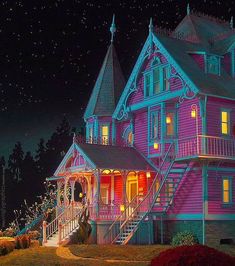 a large pink house lit up at night