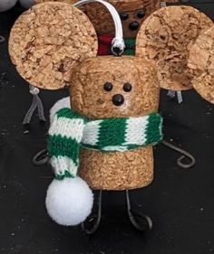 a cork mouse is wearing a green and white scarf