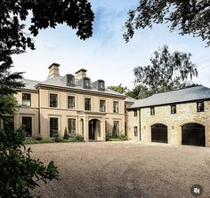 a large stone house with two garages