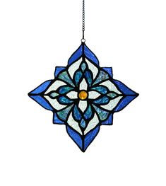 a stained glass sun catcher hanging from a chain