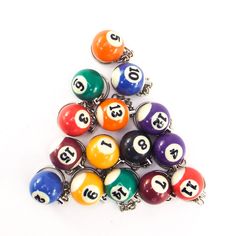 a pile of colorful pool balls sitting on top of each other in front of a white background