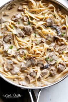 a skillet filled with pasta and meatballs