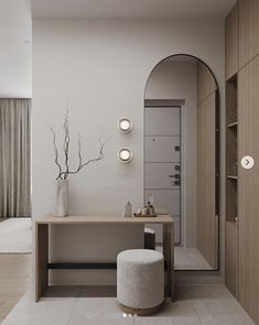 a room with a table, stool and mirror on the wall in front of it