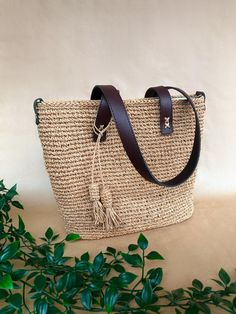 Expertly handwoven using eco-friendly yarn, raffia bag offers a natural, earthy texture that is both lightweight and durable. The design is elevated with genuine leather straps and a reinforced leather base, ensuring a comfortable carry and enhanced durability. ✨ Key Features for You: - High-Quality Materials: Knitting leather bag crafted from sustainable raffia and genuine leather, with metal hardware that ensures durability. - Spacious Interior: The light-colored lining adds a touch of elegance, featuring a roomy compartment to fit all your daily essentials - perfect for books, a tablet, or a beach towel. - Versatile Design: Ideal for everyday use - whether for work, a stroll in the park, or a beach day. Its neutral tone complements a variety of outfits, from casual jeans to a flowing su Luxury Natural Straw Bag With Open Weave, Luxury Woven Straw Bag, Luxury Jute Straw Bag With Handles, Luxury Jute Straw Bag For Summer, Cheap Everyday Woven Straw Bag, Luxury Elegant Straw Bag With Natural Fiber, Luxury Brown Straw Bag Made Of Natural Fiber, Luxury Everyday Jute Straw Bag, Cheap Woven Straw Bag With Double Handles