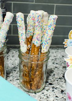 some pretzels are sitting in a jar on the counter