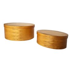 two round wooden boxes sitting next to each other