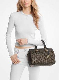 Our Grayson duffel is a glamorous finishing touch to any outfit. Covered in our metallic Empire monogram print, it’s topped with our charm and pyramid-stud accents for added shine. Top handles and an adjustable shoulder strap mean there are multiple ways to wear it. Monogram Prints, Michael Kors Collection, Metallic Logo, Signature Logo, How To Take Photos, Satchel, Shoulder Strap, Women Handbags, Michael Kors