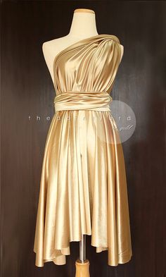 a mannequin with a gold dress on display