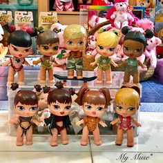 a group of little dolls sitting on top of a counter