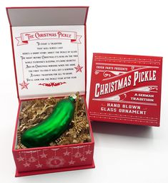 a christmas pickle in a red gift box