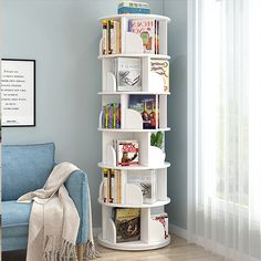 a white book shelf with books on it in a room next to a blue chair