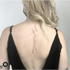 a woman with a tattoo on her back