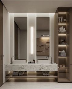 a bathroom with marble counter tops and lights on the wall, along with two sinks