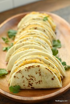 a plate filled with tortillas on top of a wooden table