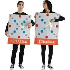 two people holding up scrabble boards with words on them