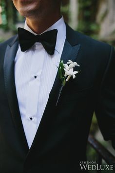 a man in a tuxedo with a flower on his lapel