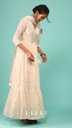 Walk down with elegance and class in our royal egret white anarkali kurta in lucknowi style embroidery. The kurta is fabricated in cotton with a net dupatta. The kurta comes in an angarakha pattern cut with peplum style and a frill at the bottom.