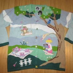 a child's sweater with an image of a teddy bear and other animals on it