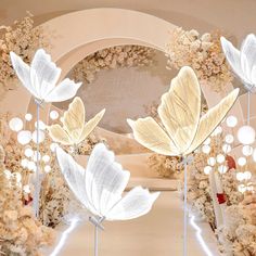 an artistic display with white flowers and lights