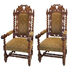 a pair of carved wooden chairs sitting next to each other