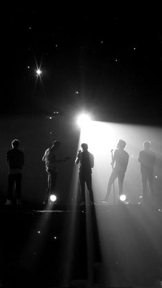 several people standing in front of a stage light