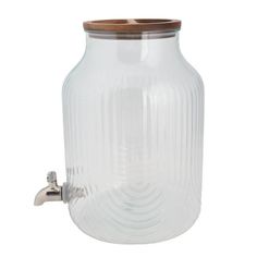 a glass jar with a wooden lid on the side and a faucet attached to it