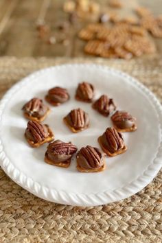 a white plate topped with nuts on top of a table