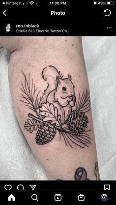 a tattoo with a squirrel and pine cones on it