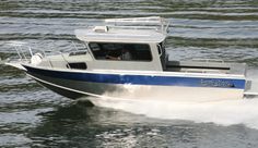 a blue and white boat traveling through the water