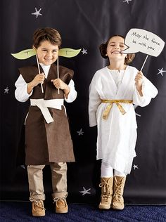 two children dressed up as jesus and mary the virgin with paper cutouts in front of them