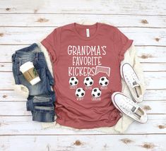 a t - shirt that says grandma's favorite soccer team on it next to some shoes