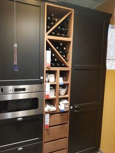 a kitchen with an oven, microwave and other items in the cupboards next to it