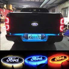 the back end of a ford truck with four different color lights in front of it