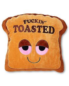 a toasted bread pillow with pink eyes and the words puck'n toasted on it