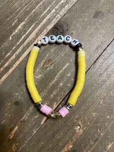 Description Show your appreciation for your favorite teacher with this fun and stretchy Teacher Clay Beaded Bracelet. Each side features colorful clay beads resembling a pencil, with the word TEACH in the center. Perfect as a gift for the teacher who never takes themselves too seriously! Details fits: 6.5" to 7" wrist disc shaped clay beads yellow, pink, gold spacer beads the Word TEACH in white and black Features One of a kind, fashion jewelry, everyday jewelry Great gift for that special girl, Bracelet For Teacher Gift Ideas, Black Clay Bracelet Ideas, Friends Themed Bracelets, Clay Bead Bracelet Ideas For Teachers, Clay Bead Apple Watch Band, Cute Bracelets With Clay Beads, Multicolor Adjustable Beaded Bracelets For Teacher Appreciation, Adjustable Multicolor Beaded Bracelets For Teacher Appreciation, Black Clay Bead Bracelet Ideas