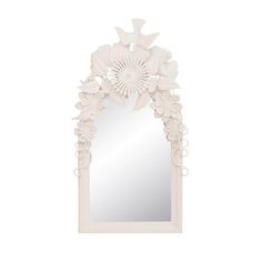 a white wall mirror with flowers on the front and back side, in an ornate frame