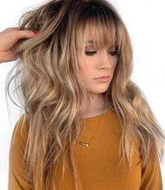 #3: Long Choppy Shag with Bangs This choppy shag with fringe is oozing major flirty vibes. Midshaft waves add to the dimension created by the balayage and give plenty of beauty for admirers to ogle at. Long Layers With Bangs, Layered Haircuts With Bangs, Long Face Shapes, Layered Hair With Bangs, Beige Blonde, Long Layered Haircuts, Long Bangs, Long Hair With Bangs