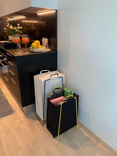 two bags sitting next to each other in front of a counter with drinks on it