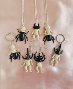 Super cute n creepy mutant beetle babies! Soooo creepycute and pastel goth! Each unique piece is handmade and one of a kind, some beetle babies are more beetle and some are more baby, some have baby bodies and some have bug bodies. They feature pinchers like a stag beetle or rhinocerous beetle, and have creepy beetle-like bodies and legs fusing with the human-like baby body parts. Keychains, necklaces, and earrings available!! Feel free to contact me about switching around the style for example swapping a necklace to a keychain. The beetle baby creatures measure approx 5cm in length. There are several styles available so please refer to the last photo when choosng a style number! :) They are a lovely gift for any pastel goth babe or appreciator of creepycute things! xoxo Cute Handmade Halloween Jewelry, Quirky Handmade Halloween Jewelry, Creepy Necklace, Immaculate Vibes, Bug Gifts, Taxidermy Jewelry, Jewelry Keychain, Goth Necklace, Keychain Necklace