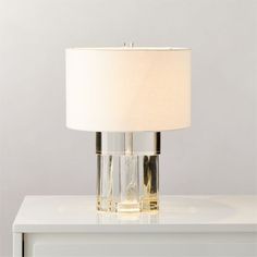 a white table with a lamp on top of it