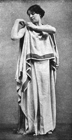 an old black and white photo of a woman dressed in roman garb with her arms crossed