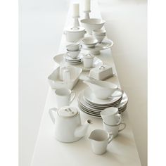 white dishes and cups lined up on a table