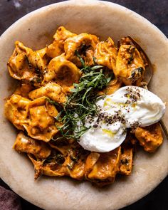 a bowl filled with pasta and sauce on top of a table