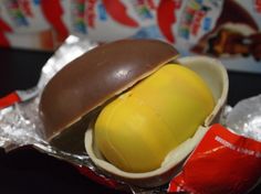 there is an egg in the shell with chocolate on it and candy bar wrapper