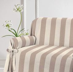 a striped couch with a flower in the corner