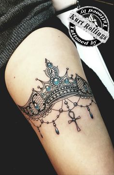 a woman's thigh with a crown tattoo on it