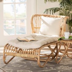 a wicker chaise lounge chair with cushion and coffee table in front of a window